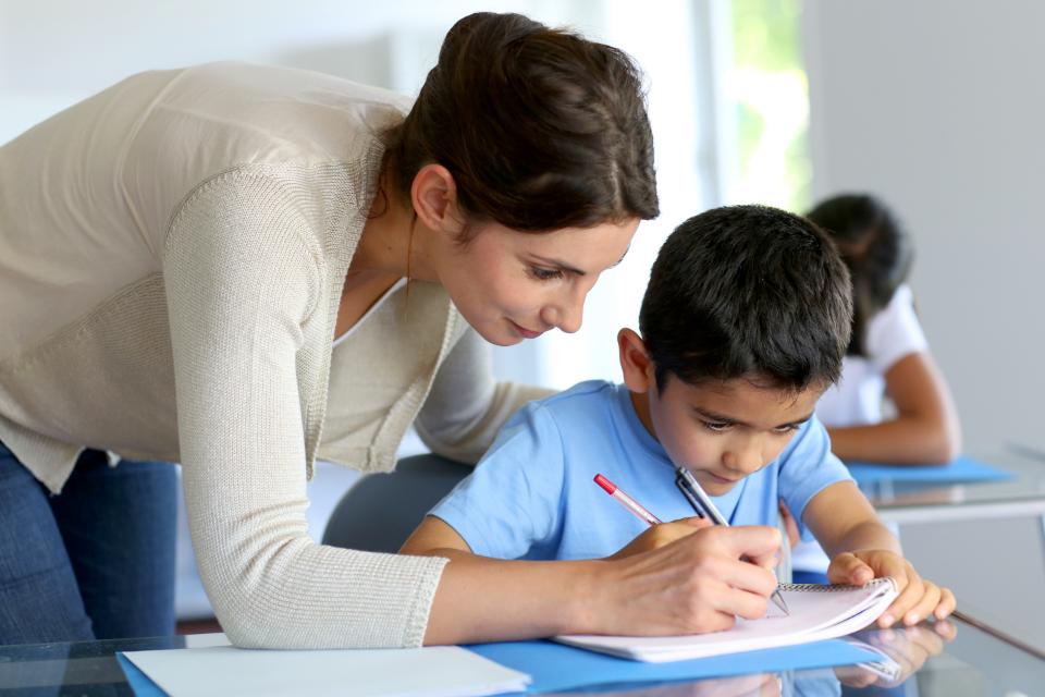 Mother helping her child with his homework