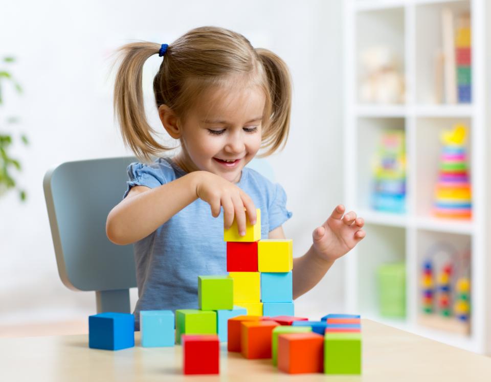 Girl playing with colored cubes