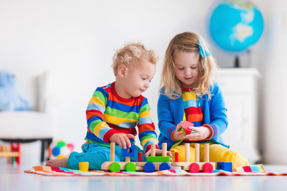 Chidren playing with wooden toys